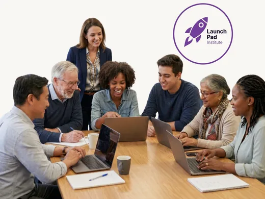 Diverse group of adult learners collaborating on laptops at a Launch Pad Institute workshop